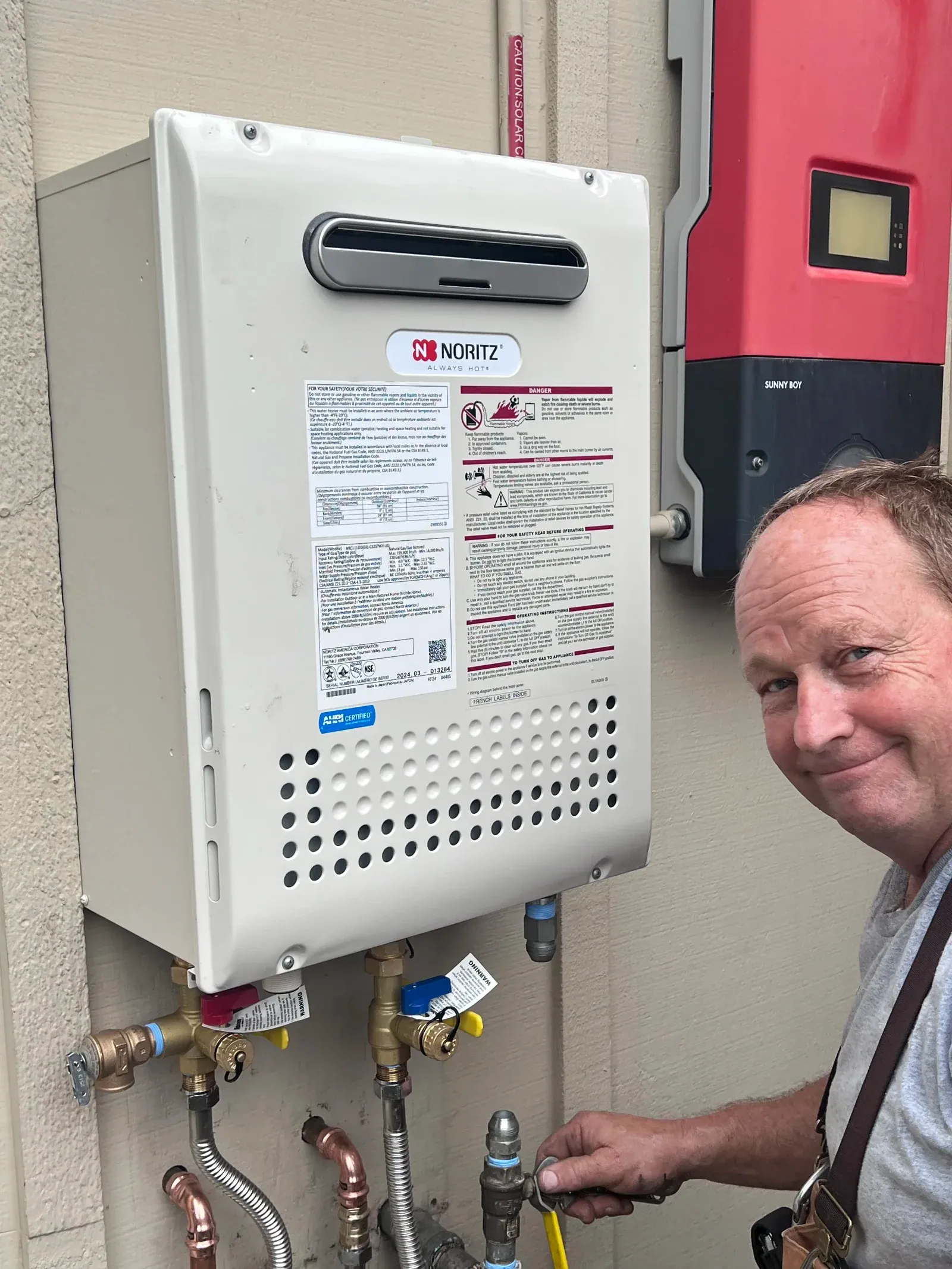 Owner Dan Phillips servicing a Noritz tankless water heater